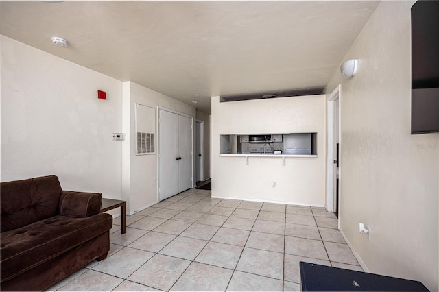 4000 SW 23rd St Unit 5-207, Gainesville, FL 32608 - living area featuring light tile patterned flooring and baseboards