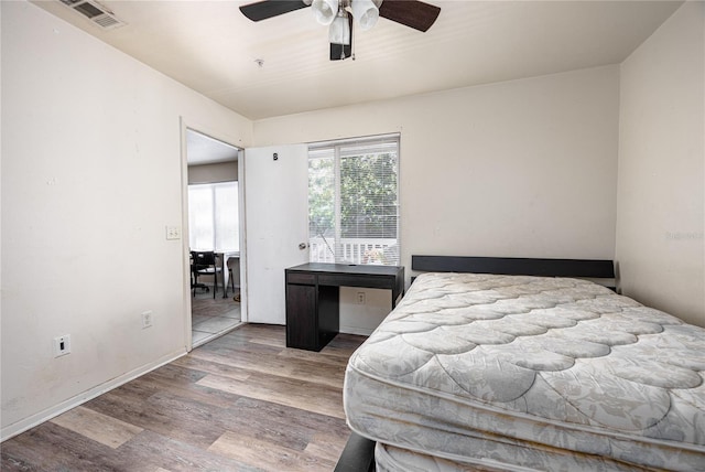 bedroom with ceiling fan and wood-type flooring