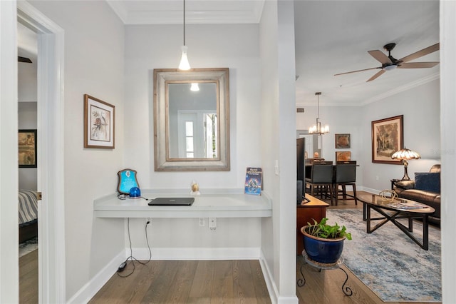 interior space featuring hardwood / wood-style floors, an inviting chandelier, and crown molding