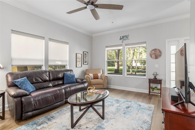 living room featuring light hardwood / wood-style flooring, ceiling fan, and crown molding