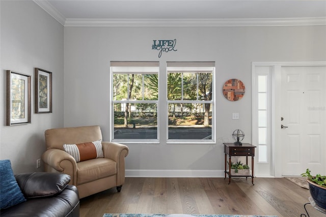 sitting room with wood-type flooring and ornamental molding