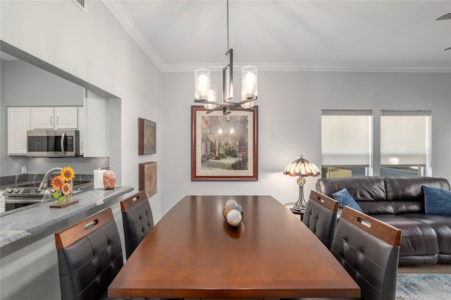 dining area featuring crown molding and an inviting chandelier