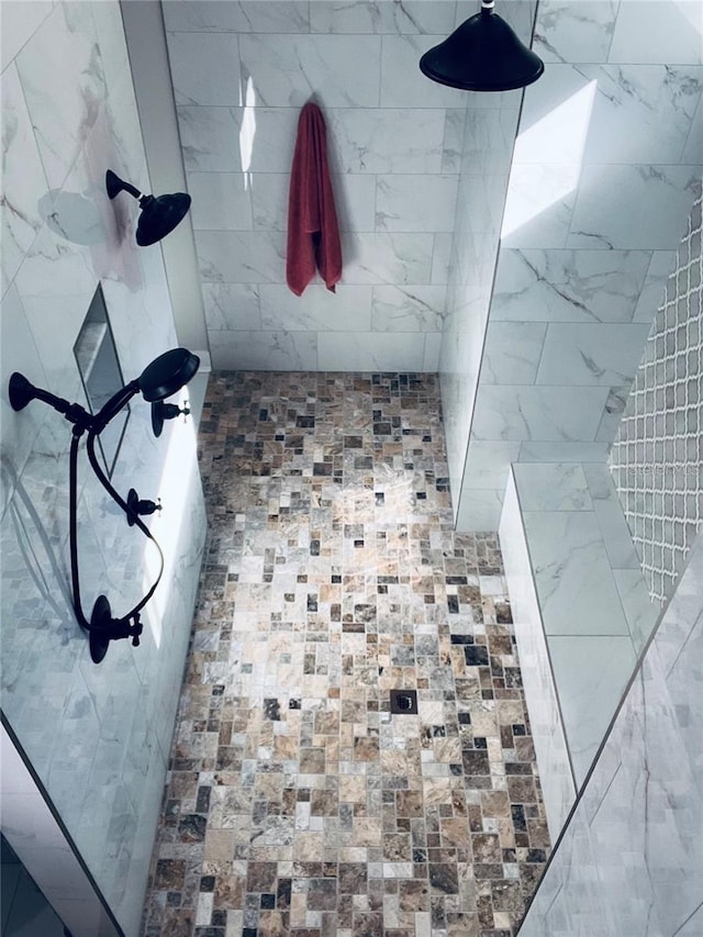 bathroom with tiled shower