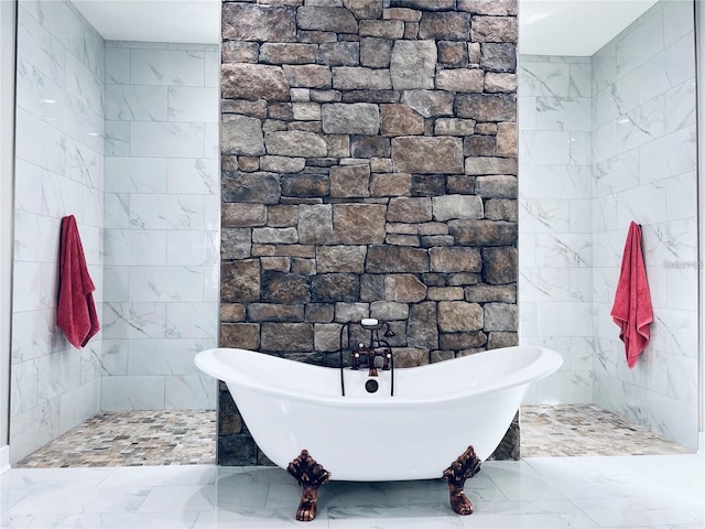 bathroom with a bath and tile walls