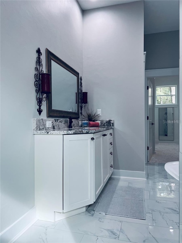 interior space featuring white cabinetry and dark stone counters