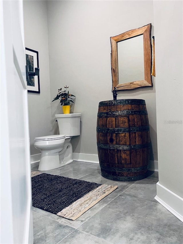 bathroom featuring toilet and concrete floors