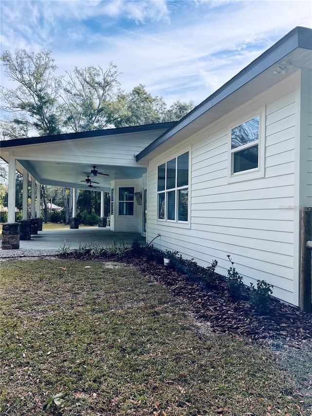 back of property with ceiling fan and a patio area