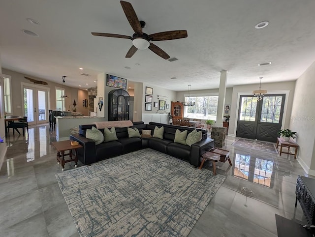 living room featuring french doors and a notable chandelier