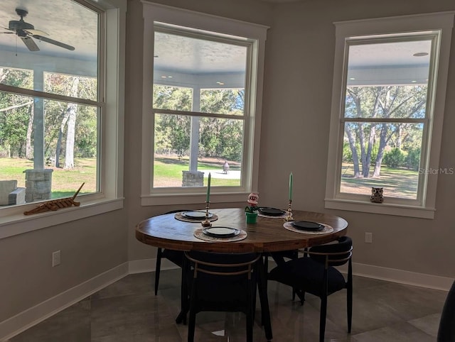 tiled dining space featuring ceiling fan