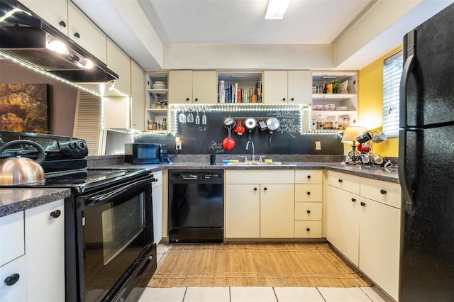 kitchen featuring decorative backsplash, light tile patterned floors, sink, and black appliances