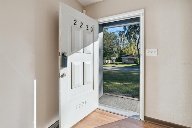 entryway with hardwood / wood-style floors