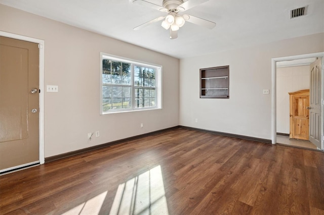 unfurnished living room featuring ceiling fan and dark wood-type flooring