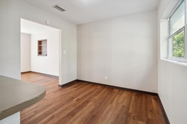 spare room with hardwood / wood-style floors