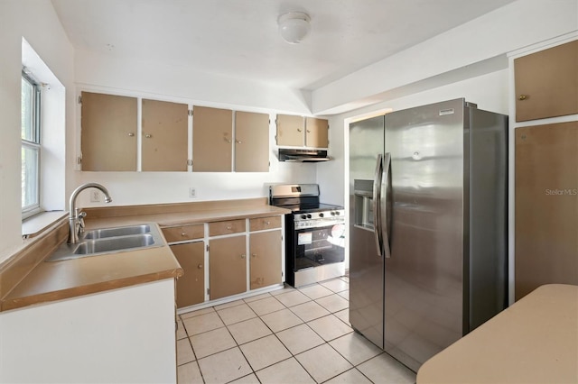 kitchen with sink, light tile patterned floors, and appliances with stainless steel finishes