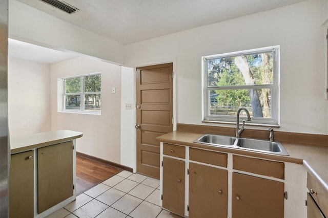 kitchen featuring sink and light tile patterned flooring