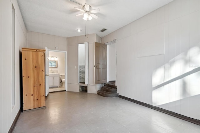 spare room with ceiling fan and a textured ceiling