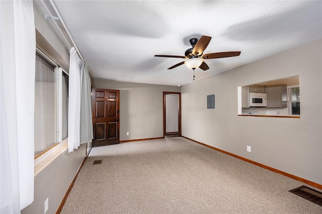 unfurnished bedroom featuring electric panel, ceiling fan, and carpet flooring