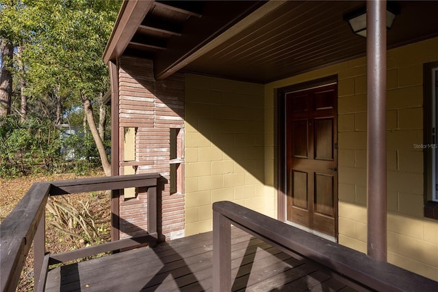 view of exterior entry featuring concrete block siding