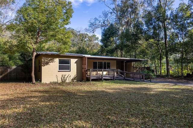 view of front facade featuring a deck and a front yard