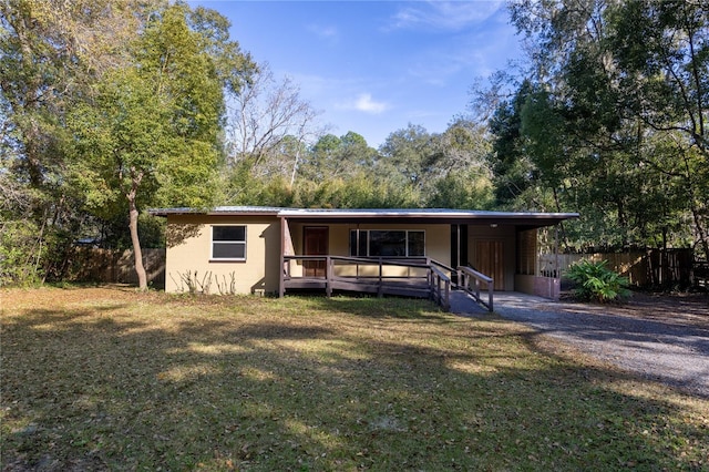 view of front of house with a porch, a front yard, and fence