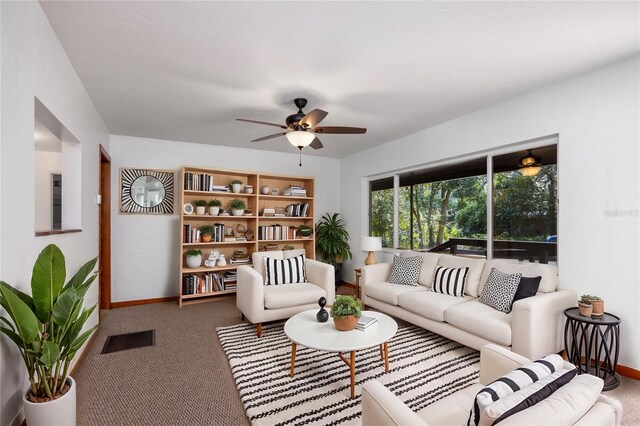 carpeted living room featuring ceiling fan, visible vents, and baseboards