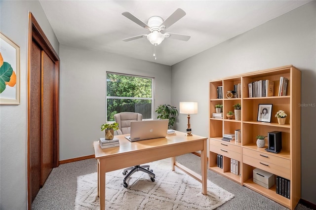 home office with ceiling fan, carpet flooring, and baseboards