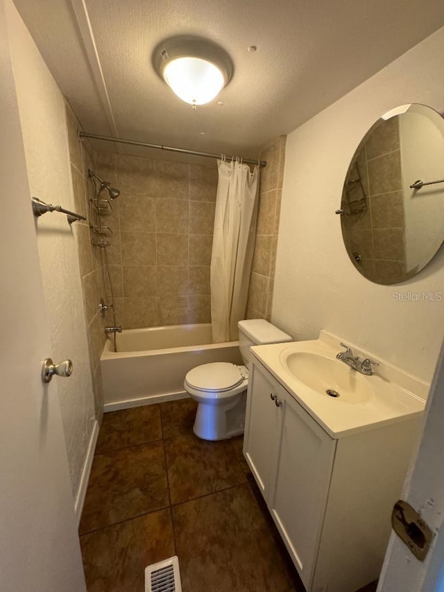 full bathroom with vanity, shower / tub combo, a textured ceiling, and toilet