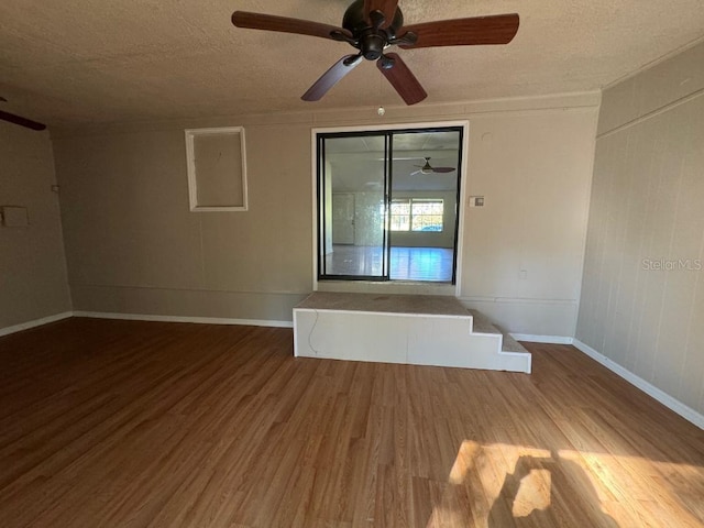 spare room featuring hardwood / wood-style floors, a textured ceiling, and ceiling fan