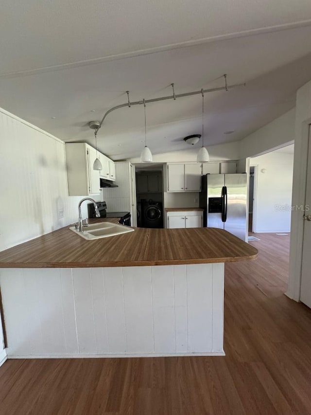 kitchen featuring lofted ceiling, dark wood-type flooring, washer / dryer, kitchen peninsula, and stainless steel appliances