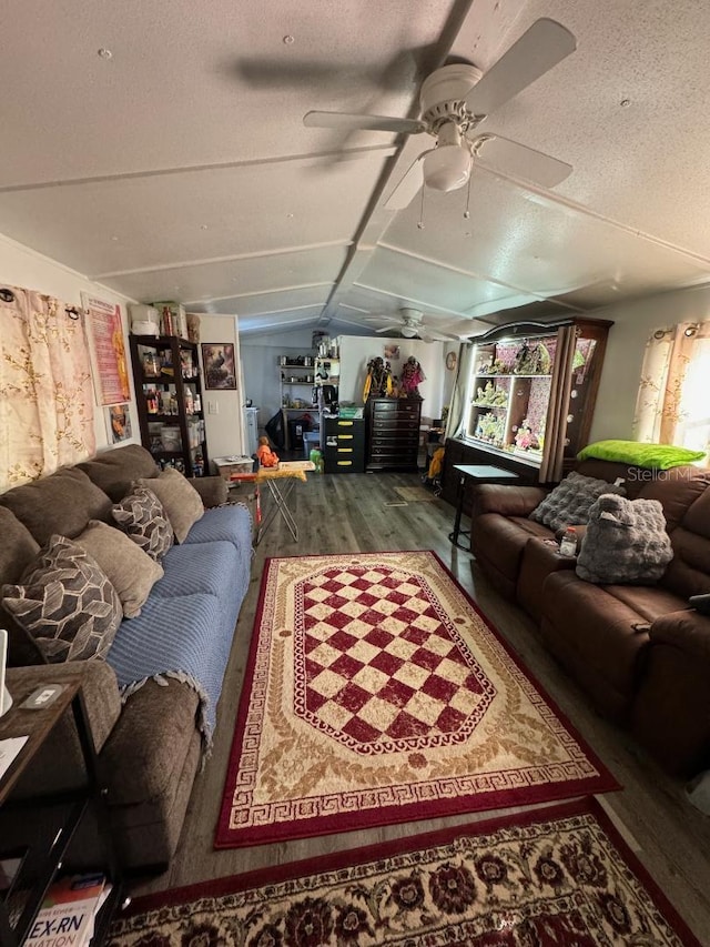 living room featuring a textured ceiling, hardwood / wood-style flooring, and lofted ceiling