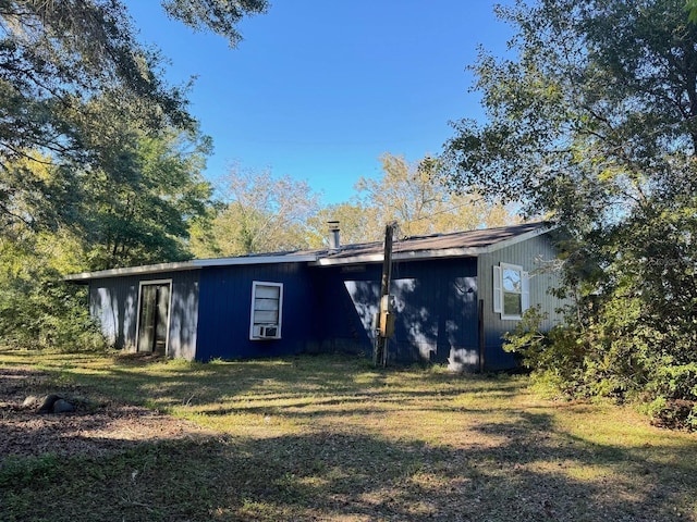 back of house with a yard and cooling unit