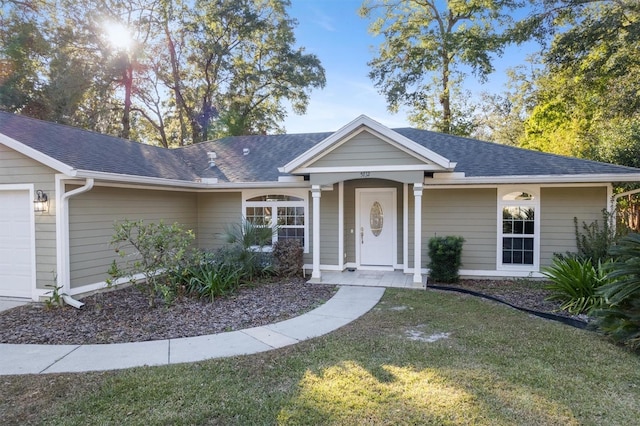 single story home featuring a garage and a front lawn