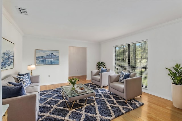 living room with hardwood / wood-style flooring and crown molding