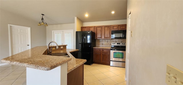 kitchen with sink, black appliances, pendant lighting, a center island with sink, and a chandelier