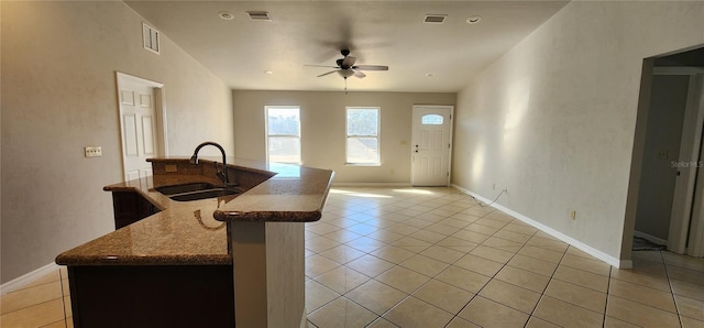 kitchen featuring a center island with sink, ceiling fan, light tile patterned floors, and sink