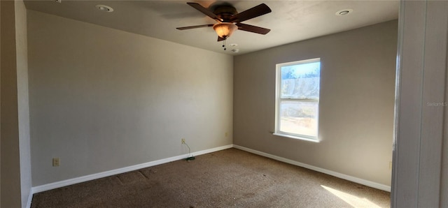 carpeted empty room featuring ceiling fan