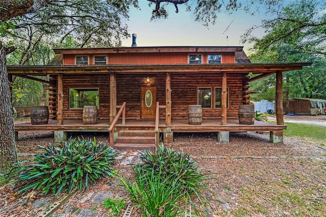 log-style house featuring covered porch