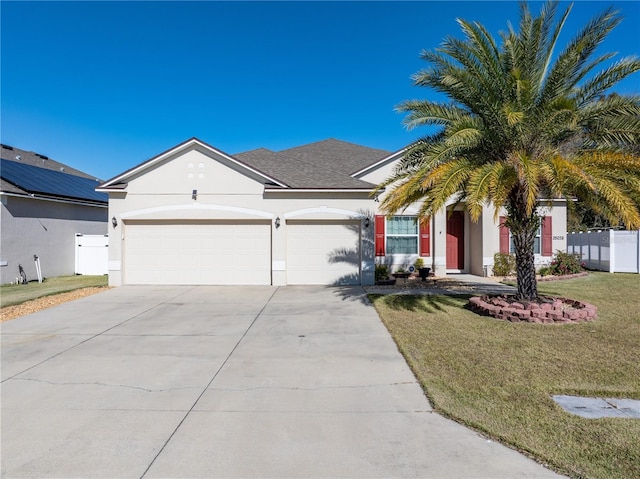 view of front of house with a front lawn and a garage