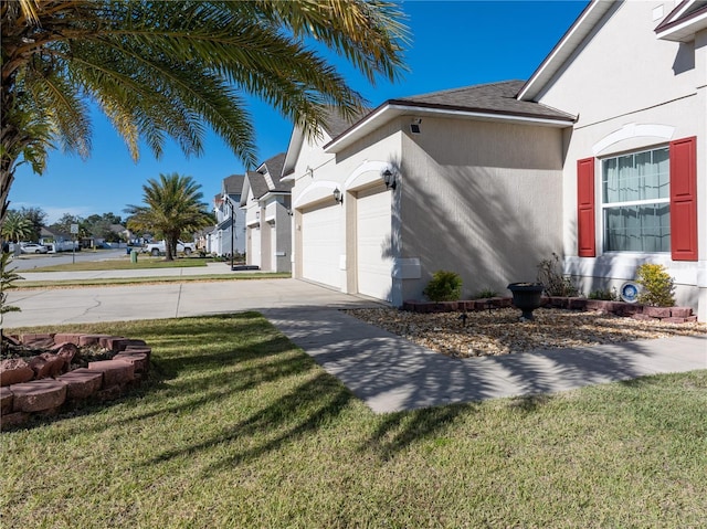 view of side of home with a garage and a yard