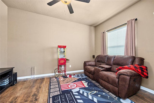 living room with ceiling fan and dark hardwood / wood-style floors