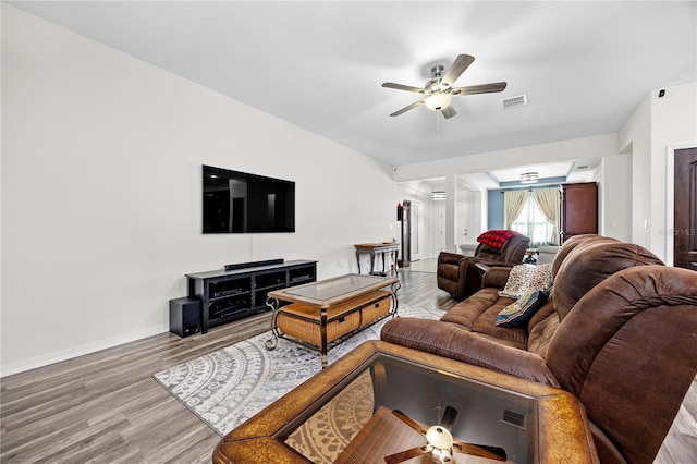 living room featuring hardwood / wood-style flooring and ceiling fan