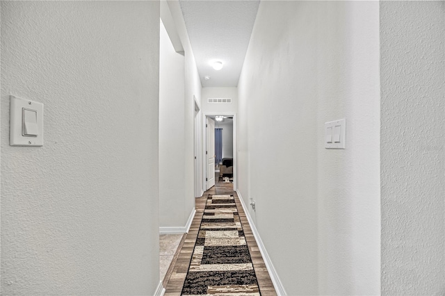 hallway with hardwood / wood-style floors