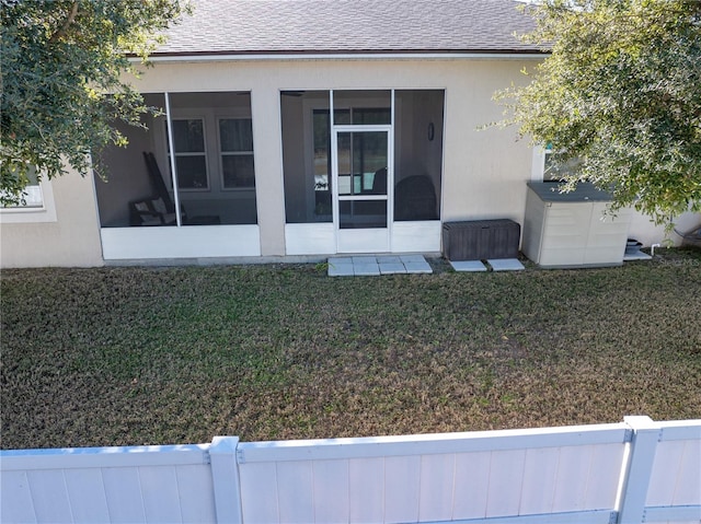 exterior space with a sunroom and a yard