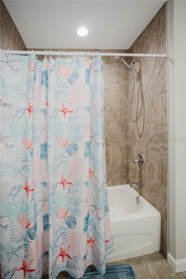 bathroom with shower / bath combo with shower curtain