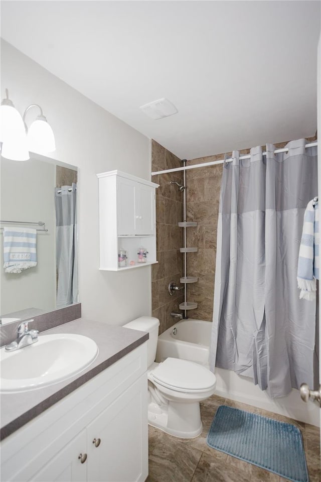 full bathroom with tile patterned floors, shower / bath combo, toilet, and vanity