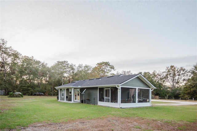 rear view of property featuring a yard