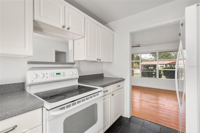 kitchen featuring dark hardwood / wood-style flooring, white cabinets, and white appliances