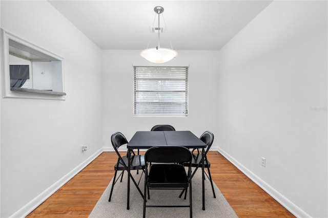 dining space with hardwood / wood-style floors