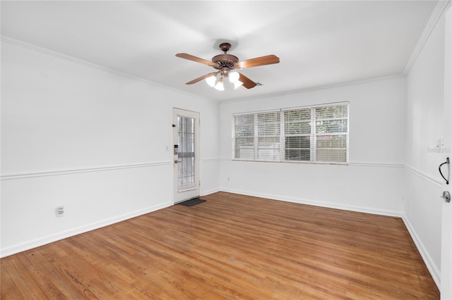 unfurnished room with ceiling fan, light wood-type flooring, and crown molding