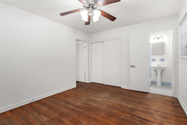 unfurnished bedroom featuring dark hardwood / wood-style flooring, ensuite bath, and ceiling fan